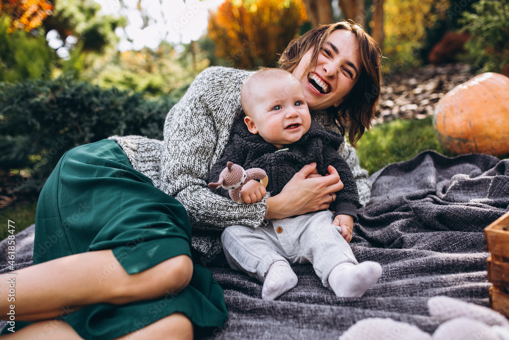 Mother with her little son having picnic on a back yard Mother with her little son having picnic on a back yard