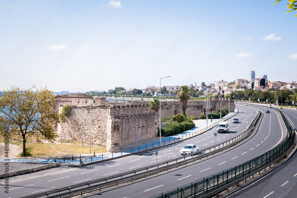 Zeytinburnu, Istanbul, Turkey - October 2021: Cars and historical walls on the coastal road of Istanbul. The historical land walls of Istanbul. Historical walls and highway in Zeytinburnu. 