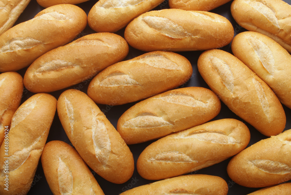 Many fresh wheat bread buns as background