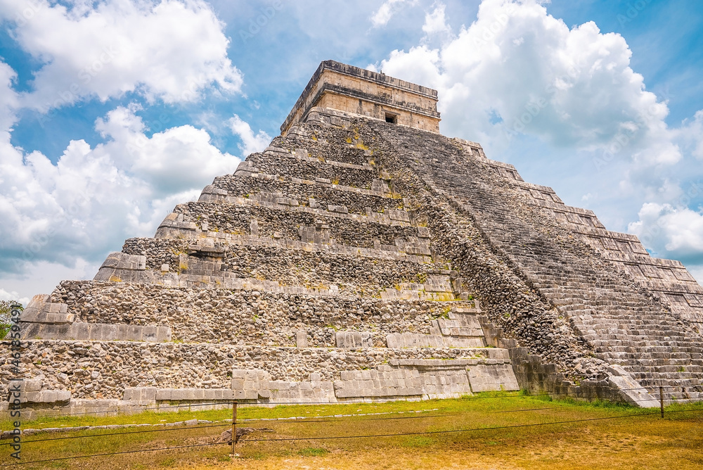 Old historic ruins of Temple of Kukulkan, pyramid in Chichen Itza against cloudy sky. Historic architectural ruins of mayan Old historic ruins of Temple of Kukulkan, pyramid in Chichen Itza against cloudy sky. Historic architectural ruins of mayan