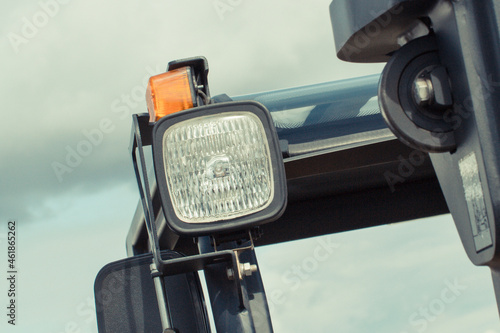 Lamp and direction indicator in tractor or other machine. Safety while driving. Transportation