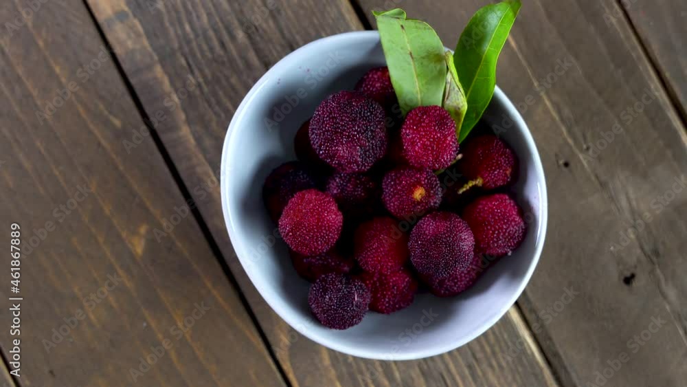 a bowl of bayberry fruit on a wooden plank a bowl of bayberry fruit on a wooden plank