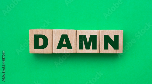 Damn word made with building blocks isolated on green