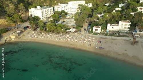 Cala Vedella beach, with boats and sailboats at anchor. Sunset in Ibiza, seen from a drone. photo