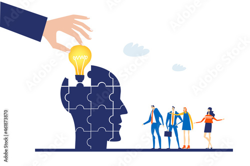 Hand of businessman places light bulb in human's head. 