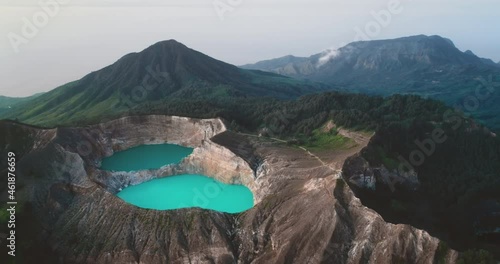 Volcano mountain blue water crater lakes. Aerial flight over turquoise aqua in Kelimutu volcanic mount. Nature background. Travel destination. Beautiful wild landscape. Crater lakes in Ende, Indonesia photo