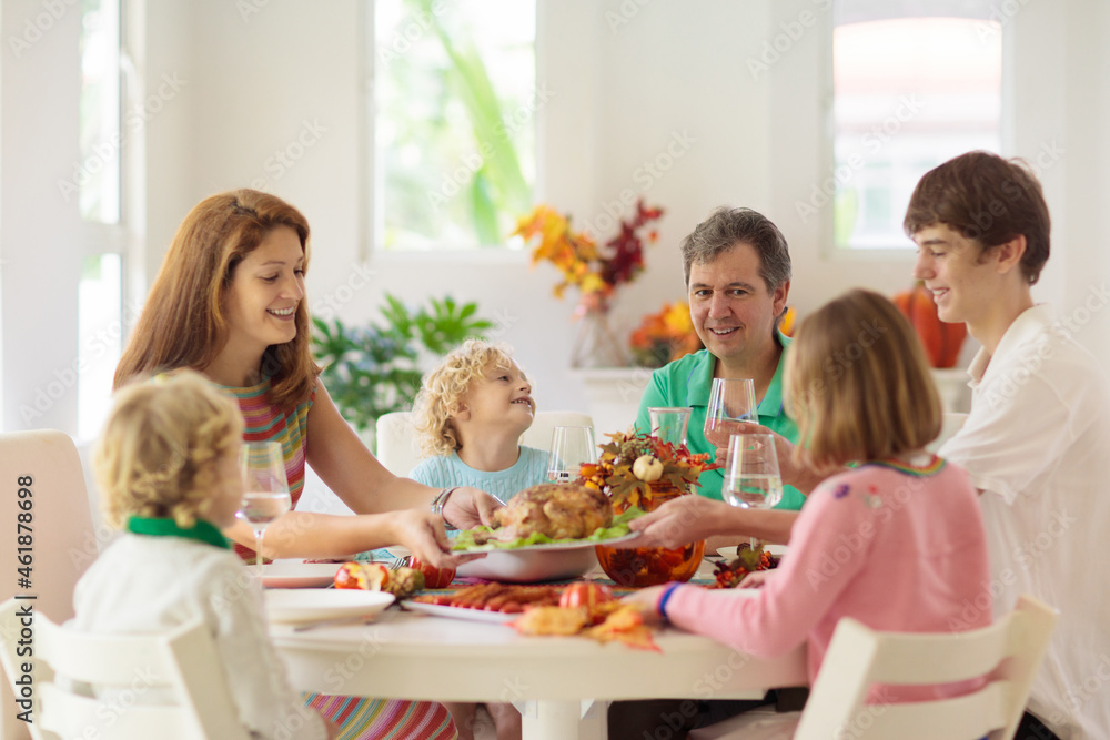 Family with kids at Thanksgiving dinner. Turkey. Family with kids at Thanksgiving dinner. Turkey.