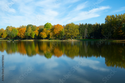 autumn trees reflected in water