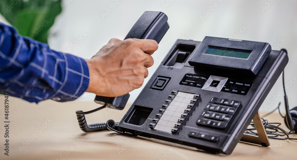 Communication support, call center and customer service help desk. telephone devices with VOIP headset in office.Customer service support (call center) concept. Communication support, call center and customer service help desk. telephone devices with VOIP headset in office.Customer service support (call center) concept.