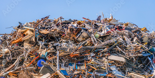 Принти на полотні Large heap of old iron objects intended for recycling against a bright blue sky