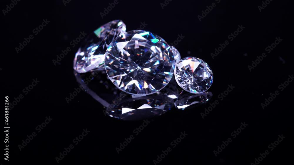 Set of big and small luxury diamonds, selective focus. Valuable and expensive gem stones for industrial and fashion applications. Scattered brilliant diamonds on black table. Display and inspection. Set of big and small luxury diamonds, selective focus. Valuable and expensive gem stones for industrial and fashion applications. Scattered brilliant diamonds on black table. Display and inspection.