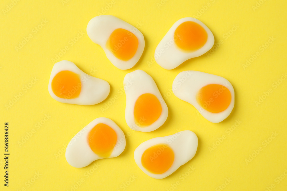 Gummy candies on yellow background, top view Gummy candies on yellow background, top view