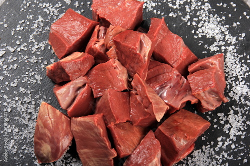 Raw sliced beef heart on black background. Top View 
