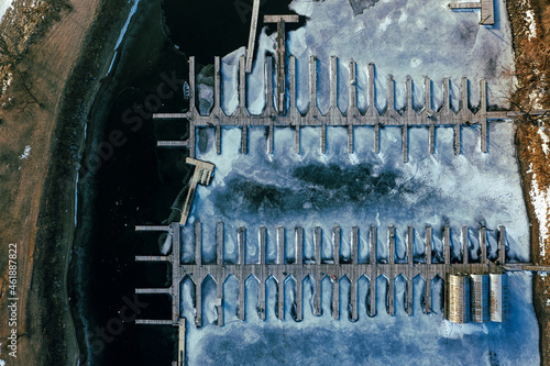 Aerial top-down view of a dock in the frozen river