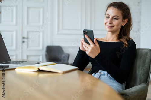 The blogger works in an office at home. Student surf the internet on break.  The freelancer prints a message to the client by email. A woman studying online on the school's website.