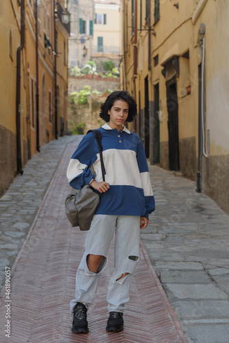 Teenage girl posing in the street of the Italian old town