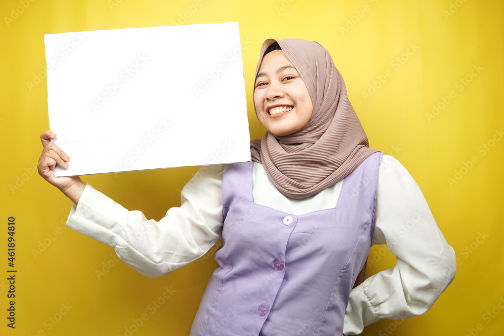 Pretty young muslim woman cheerful holding blank empty banner, placard, white board, blank sign board, white advertisement board, presenting something in copy space, promotion Pretty young muslim woman cheerful holding blank empty banner, placard, white board, blank sign board, white advertisement board, presenting something in copy space, promotion