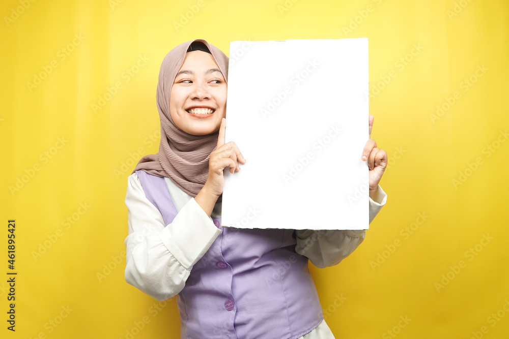Pretty young muslim woman cheerful holding blank empty banner, placard, white board, blank sign board, white advertisement board, presenting something in copy space, promotion Pretty young muslim woman cheerful holding blank empty banner, placard, white board, blank sign board, white advertisement board, presenting something in copy space, promotion