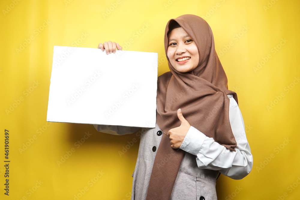 Pretty young muslim woman cheerful holding blank empty banner, placard, white board, blank sign board, white advertisement board, presenting something in copy space, promotion Pretty young muslim woman cheerful holding blank empty banner, placard, white board, blank sign board, white advertisement board, presenting something in copy space, promotion