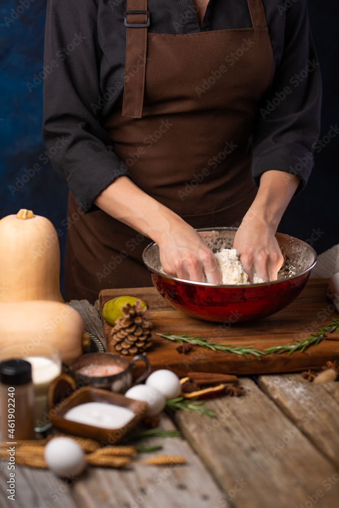 The chef kneads the dough for a traditional American pumpkin pie. Ingredients. decor. Thanksgiving, harvest holiday, Halloween, family holidays. The chef kneads the dough for a traditional American pumpkin pie. Ingredients. decor. Thanksgiving, harvest holiday, Halloween, family holidays.