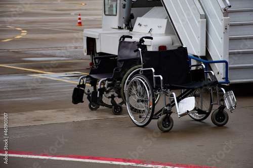 Wheelchairs in airport intended for passengers with disabilities at the ramp or airstairs photo