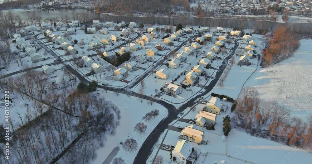 Panorama aerial view in small American town townhouse settlement the winter snow covered rooftops of residential houses cottages Panorama aerial view in small American town townhouse settlement the winter snow covered rooftops of residential houses cottages