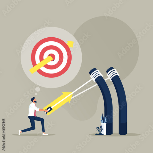 Fototapeta Businessman aiming high target with a big catapult, bullseye target to win in bu