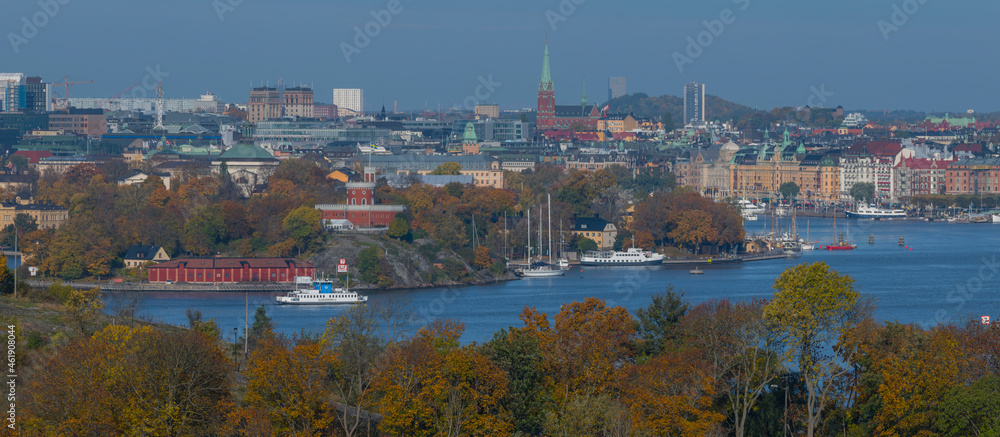 Colorful autumn view over the inner harbor of Stockholm with ferries and commuting boats a hazy day