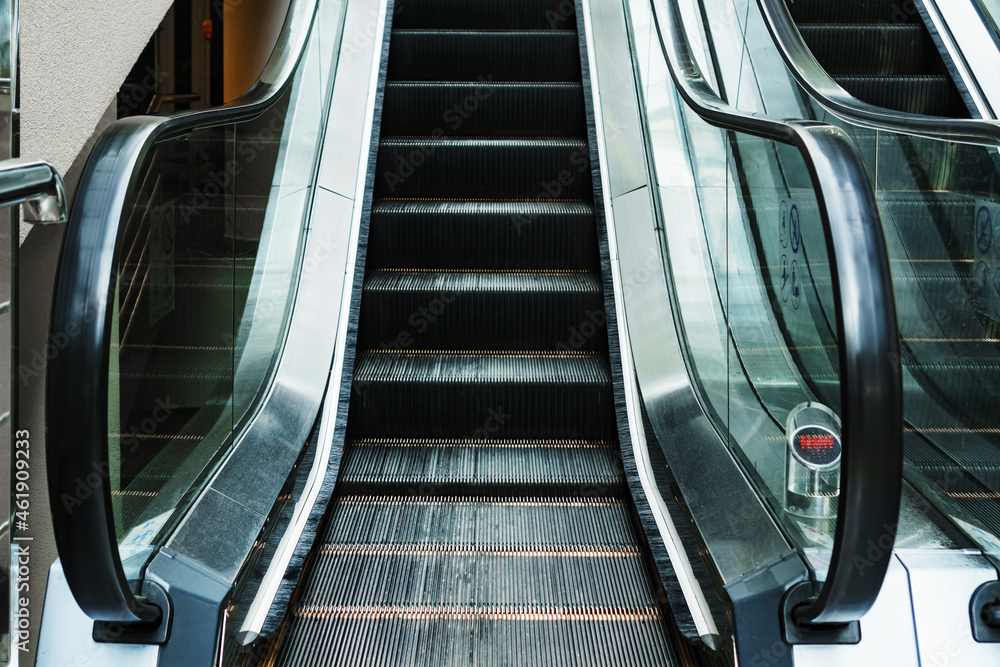 Escalator lifting steps in the waiting rooms of the station. Climbing the stairs Escalator lifting steps in the waiting rooms of the station. Climbing the stairs