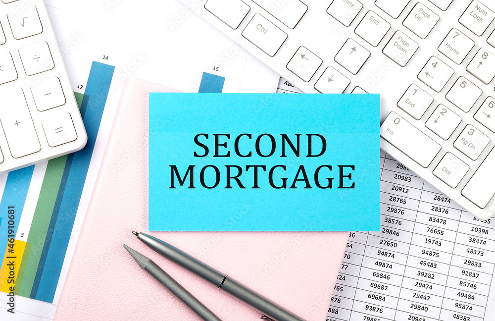 SECOND MORTGAGE text on blue sticker on chart with calculator and keyboard,Business concept SECOND MORTGAGE text on blue sticker on chart with calculator and keyboard,Business concept