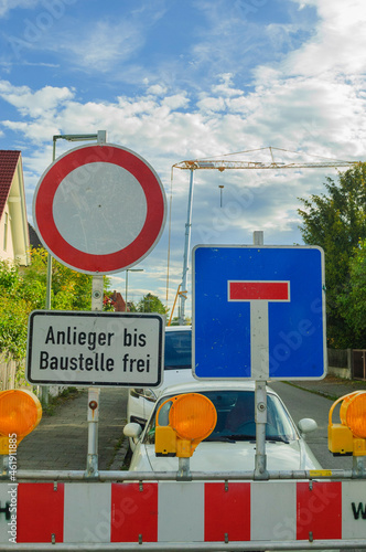 Wallpaper Mural Construction site signs in German: road closed, dead end and "open for residents" (Anlieger bis Baustelle frei) with big crane in the background Torontodigital.ca
