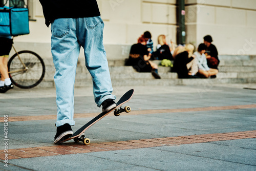 Skateboarder ride on skateboard at city street, close up