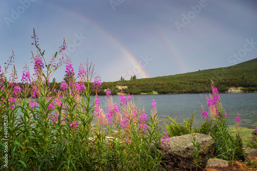 Bezbog hut in Pirin mountain Bulgaria with Bezbog lake on sunrise and sunset with rainbow photo
