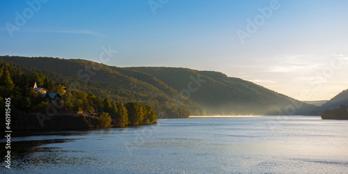 morning landscape of mountain lake at sunrise. beautiful autumnal countryside scenery with fog on the water in the distance. cold somes water reserve of cluj country  romania