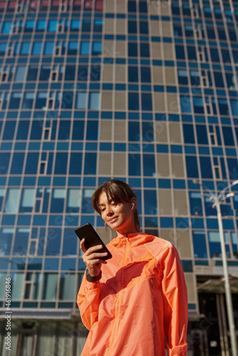 Active woman use electronic devices training outdoors © Svitlana