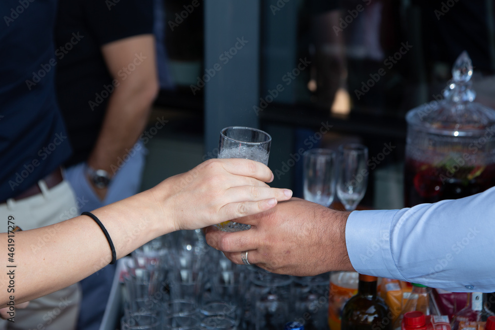 male hand holding drinking glass, close up