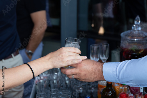 male hand holding drinking glass  close up