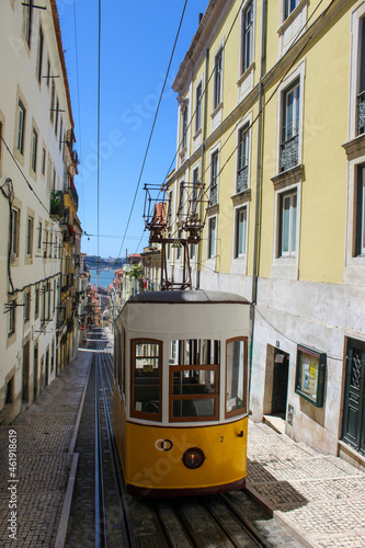Vintage tram in the city center of Lisbon in a beautiful summer day, Portugal. Traditional yellow tram on a street in Lisbon, Portugal.