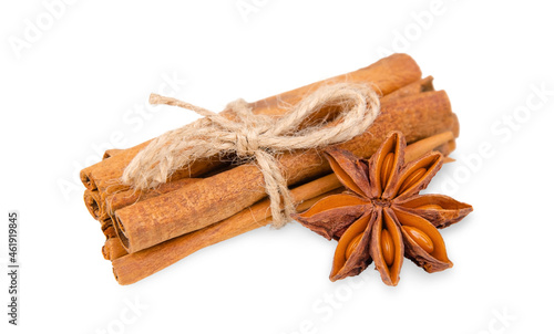 Twine tied cinnamon sticks and star anise isolated on white