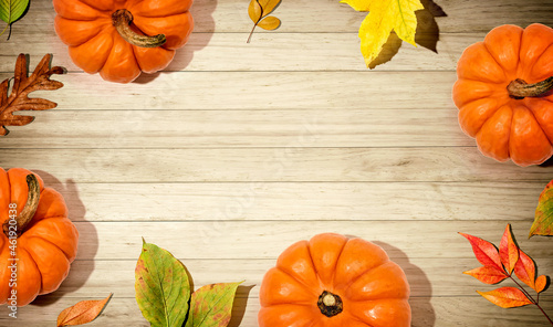 Autumn pumpkins with colorful leaves overhead view - flat lay