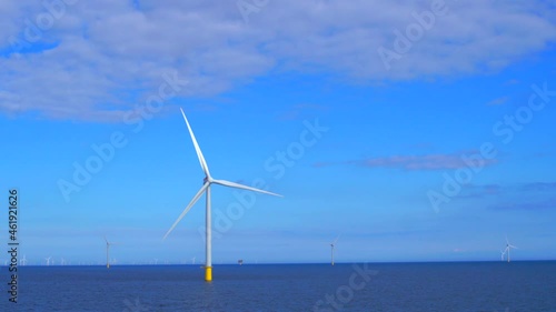 Windmills generating green energy at the sea