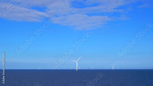 Windmills generating green energy at the sea