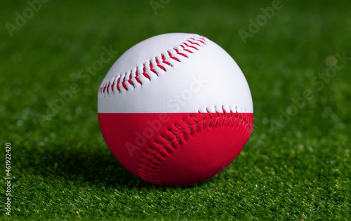Photography Baseball with Poland flag on green grass background, close up