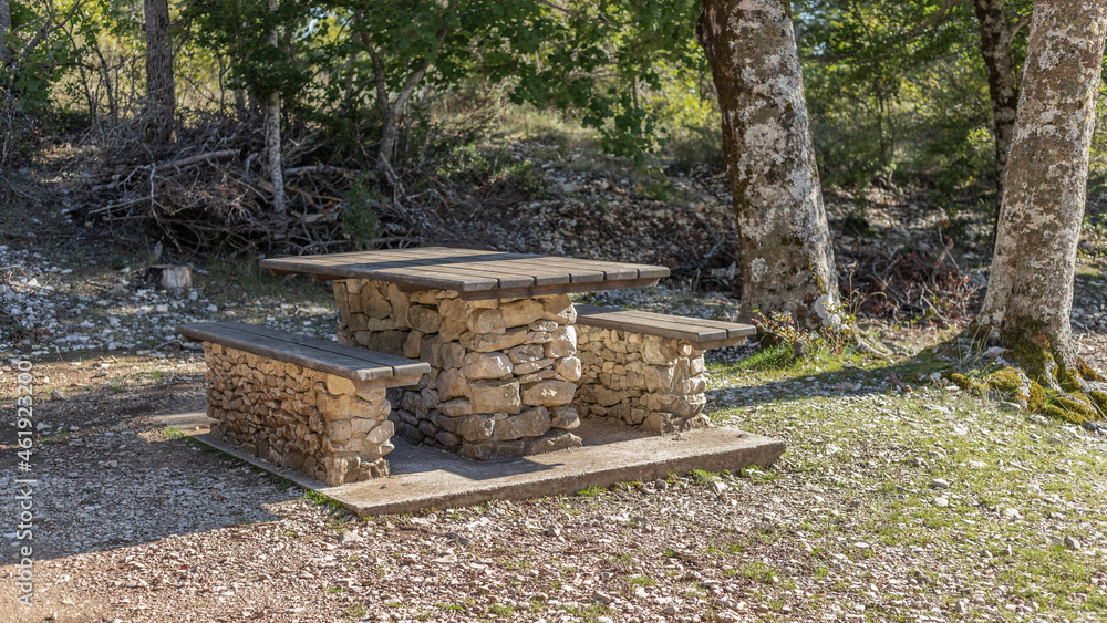 Table and bench set made out of local stone in a forest setting 