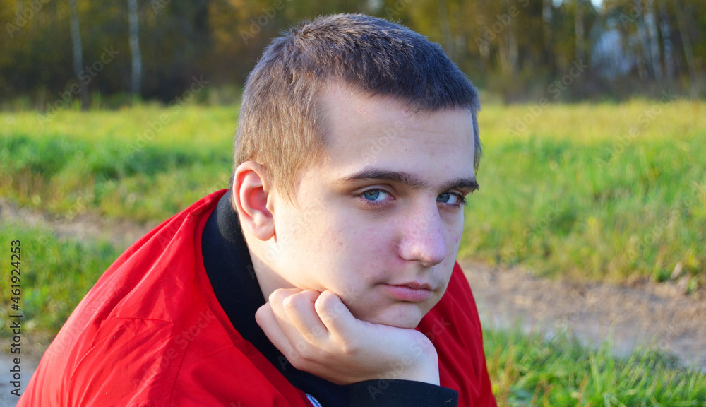 A young autistic guy with blue eyes looks at the camera A young autistic guy with blue eyes looks at the camera