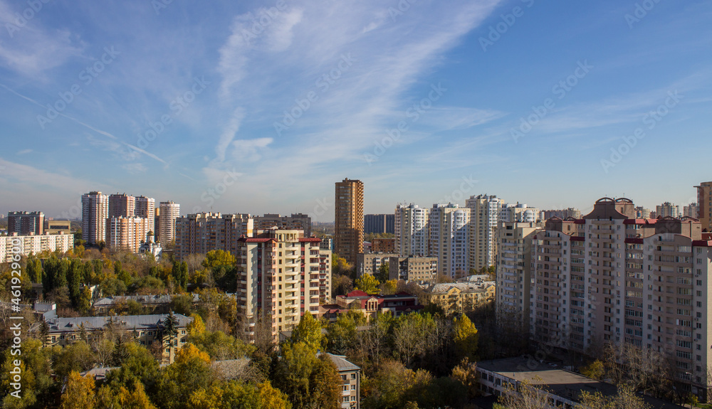 Obraz premium Cityscape - panoramic view of modern multi-storey buildings and colorful autumn trees on a sunny, clear day in Reutov, Russia.