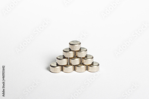 Reloading/handloading - closeup of pyramid-shaped stack of small pistol primers.