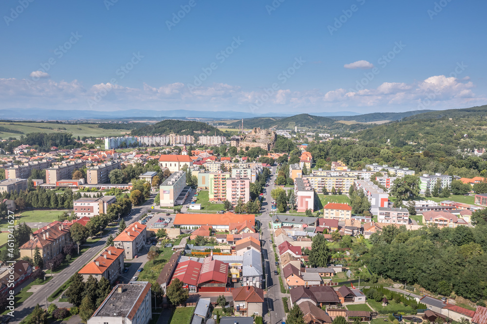 Aerial view of Filakovo town with partially restored medieval castle surrounded by communist style block house and modern center in Southern Slovakia old versus new contrast