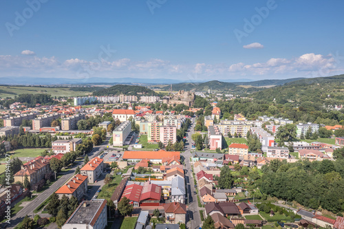 Aerial view of Filakovo town with partially restored medieval castle surrounded by communist style block house and modern center in Southern Slovakia old versus new contrast