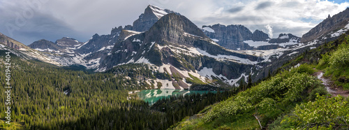 Spring Mountain Trail - A panoramic Spring evening view of Mt. Gould, Angel Wing and Grinnell Lake, as seen from Grinnell Glacier Trail. Many Glacier, Glacier National Park, Montana, USA.